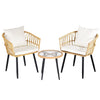 Two wicker chairs with white cushions and a matching side table on a white background