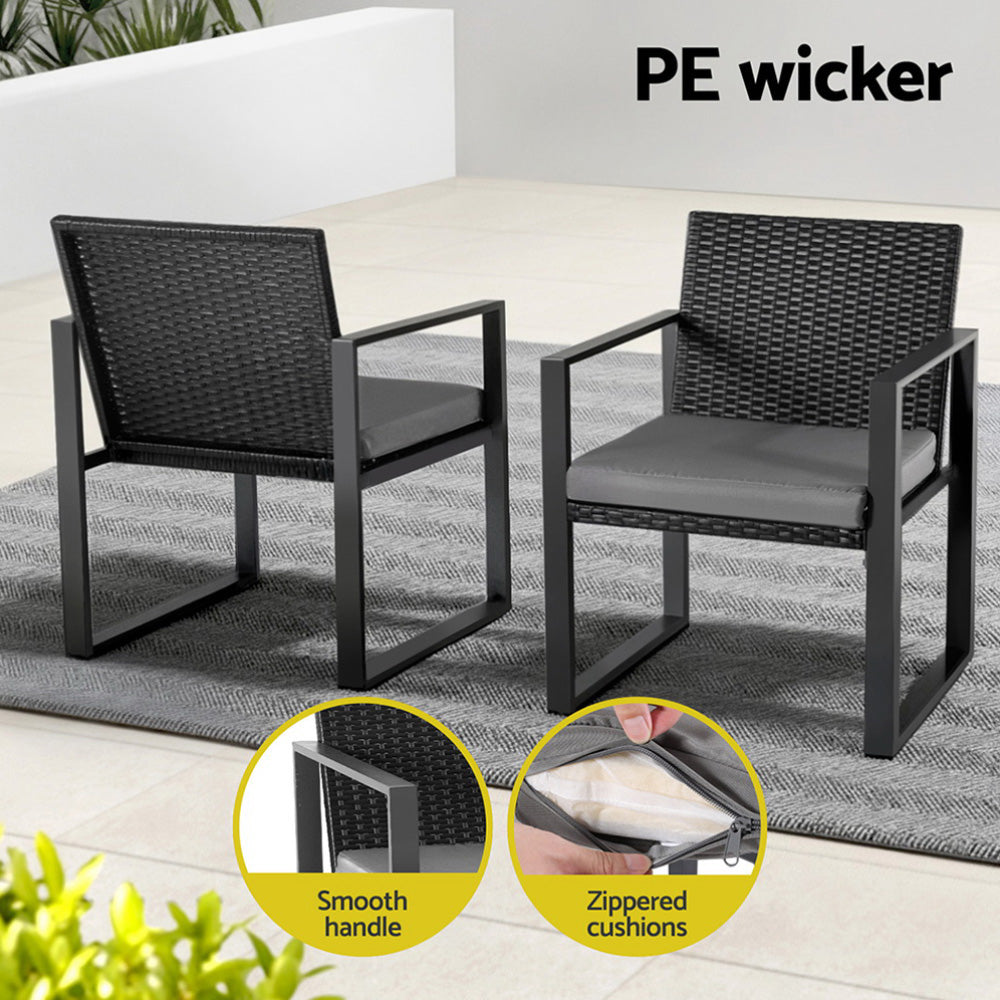 Two black wicker chairs with gray cushions on a patio, featuring smooth handle and zipped cushions.