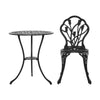 A black Gardeon round table and front view of chair with intricate cut-out tulip flower patterns, on a white background setting.
