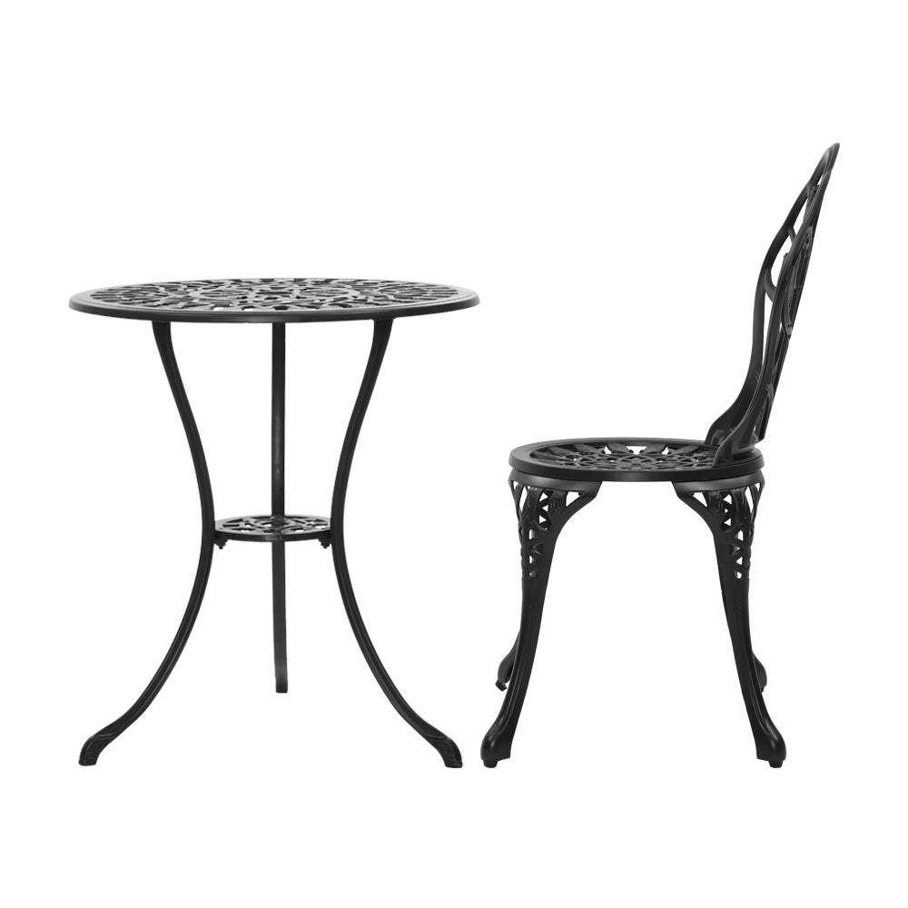 A black Gardeon round table and side view of chair with intricate cut-out tulip flower patterns, on a white background setting.