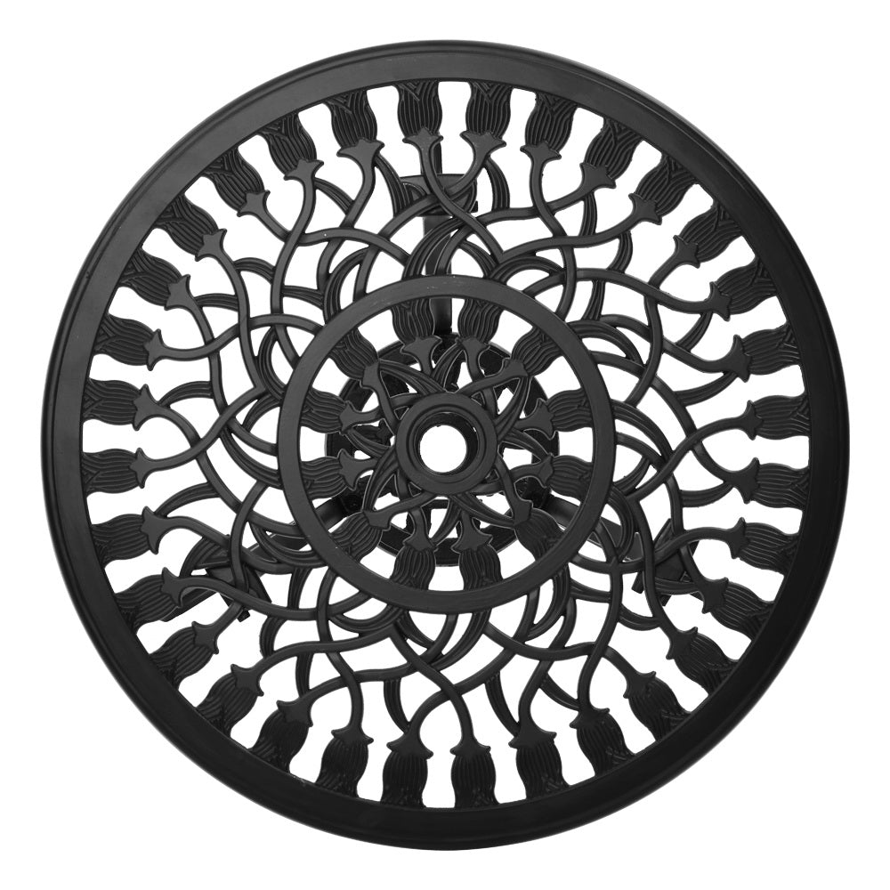 Close-up view of the black Gardeon round tabletop with intricate cut-out tulip flower patterns, and parasol hole in the middle on a white background setting.