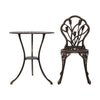 A bronze Gardeon round table and chair with intricate cut-out tulip flower patterns, on a white background setting.