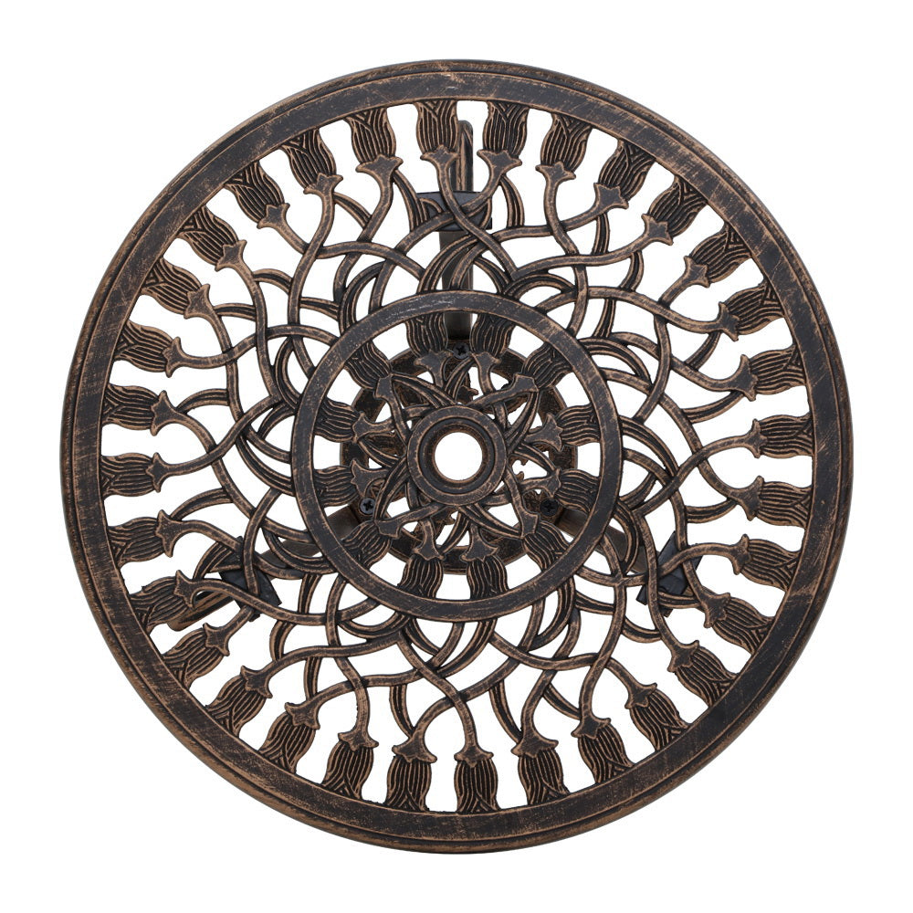 Close-up view of the bronze Gardeon round tabletop with intricate cut-out tulip flower patterns, and parasol hole in the middle on a white background setting.