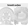 Close-up view of the back of chair and the top of seat of a white Gardeon chair with intricate patterns, set against a white background.