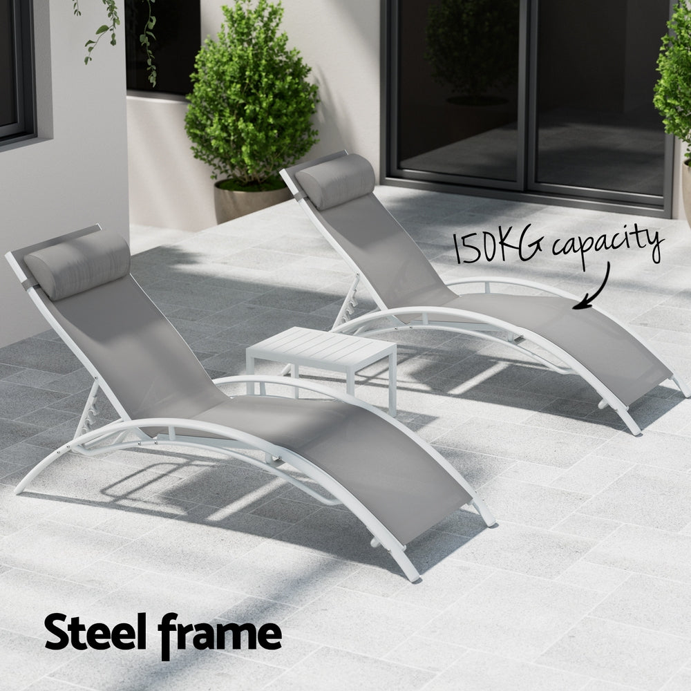Two gray lounge chairs with a steel frame on a patio area.