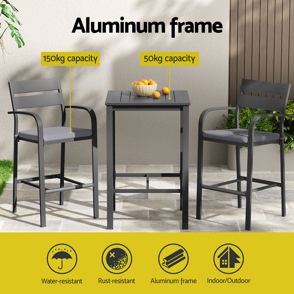 Outdoor furniture set with table and chairs on a patio, featuring an aluminum frame.