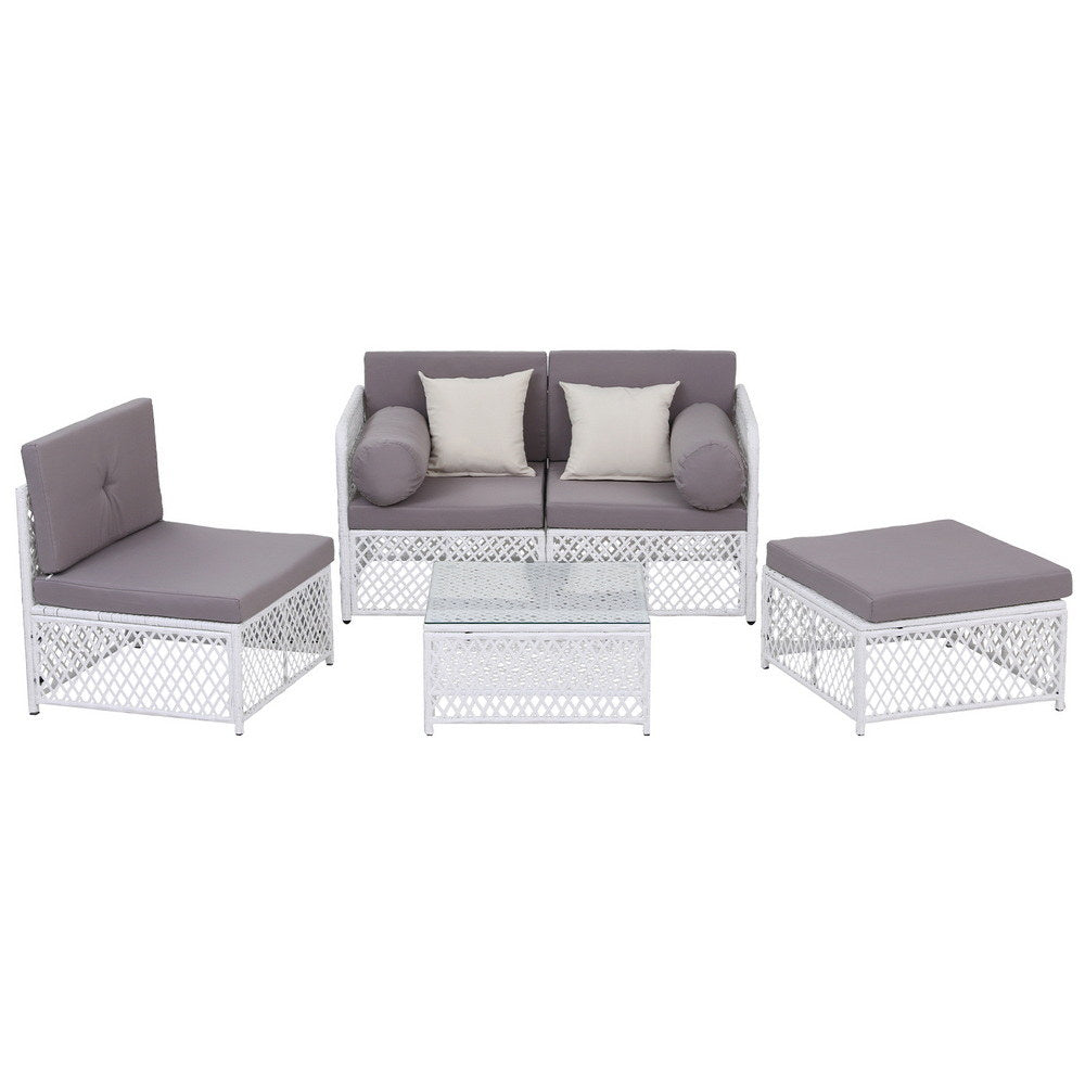 Outdoor furniture set with white frames and gray cushions on a white background