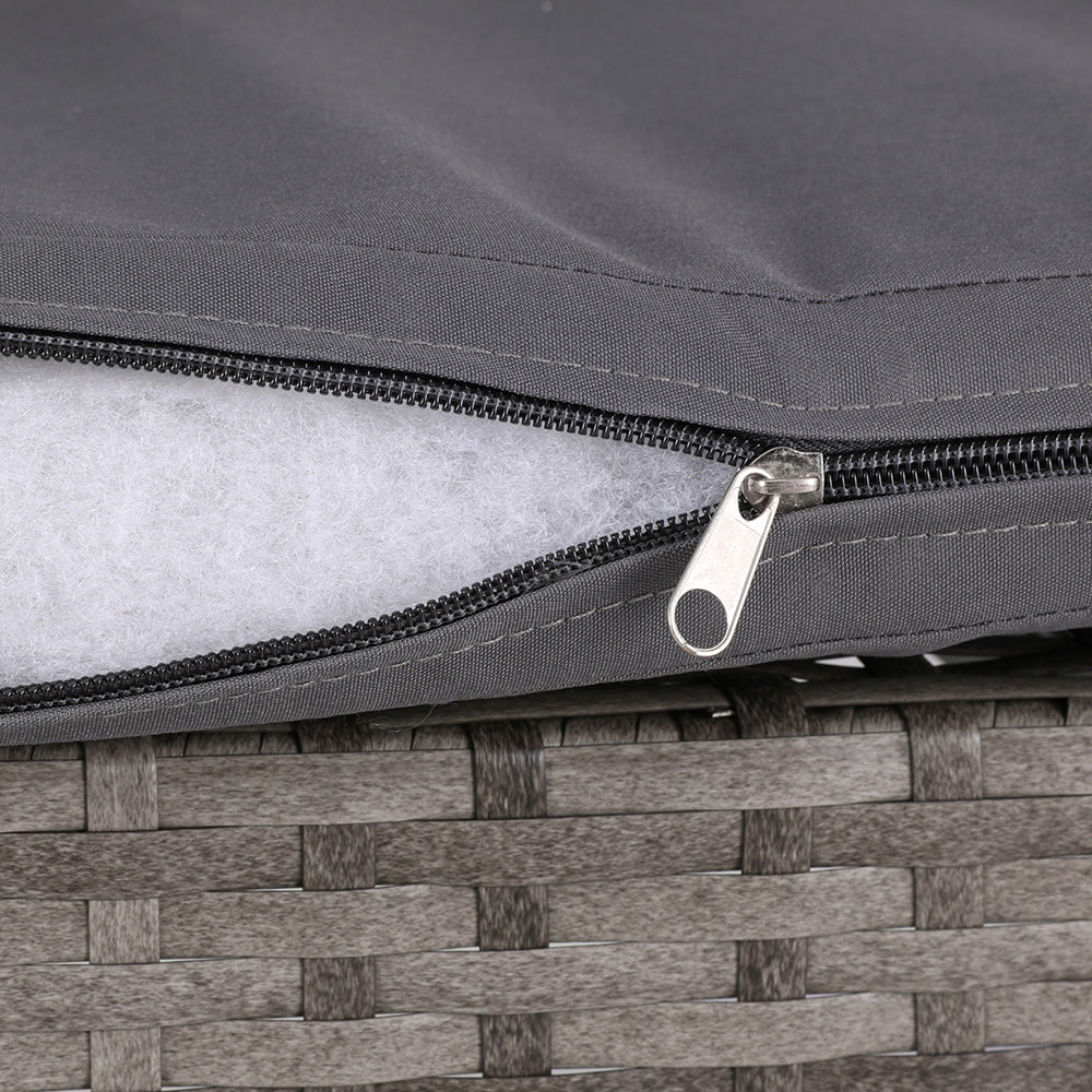 Close-up view of a wicker chair cushion in Grey with zipper open showing its stuffing and set on a white background.