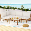 Outdoor patio set with white cushions and a small table on a deck.