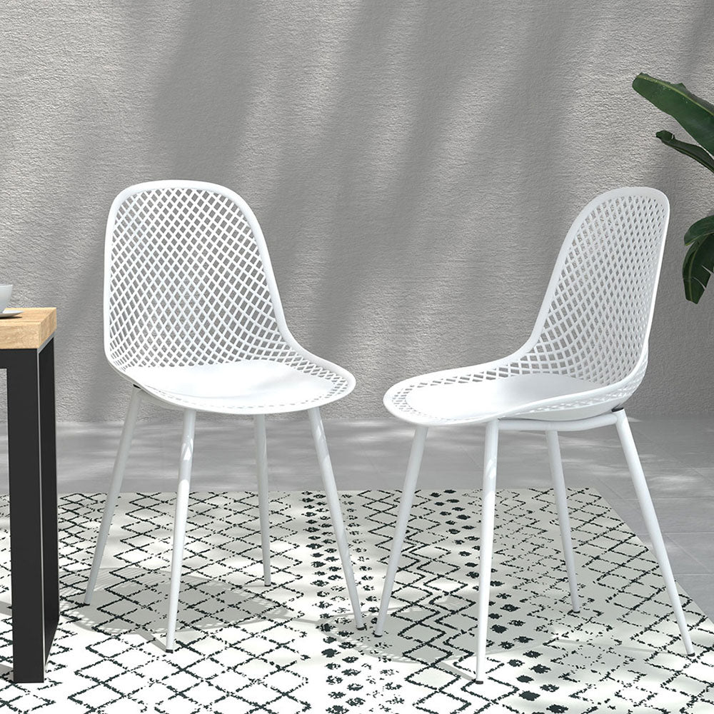 Pair of Gardeon Outdoor Dining Chairs in White facing toward each other set on a black and white patterned floor mat on a tiled floor with a wall behind it.