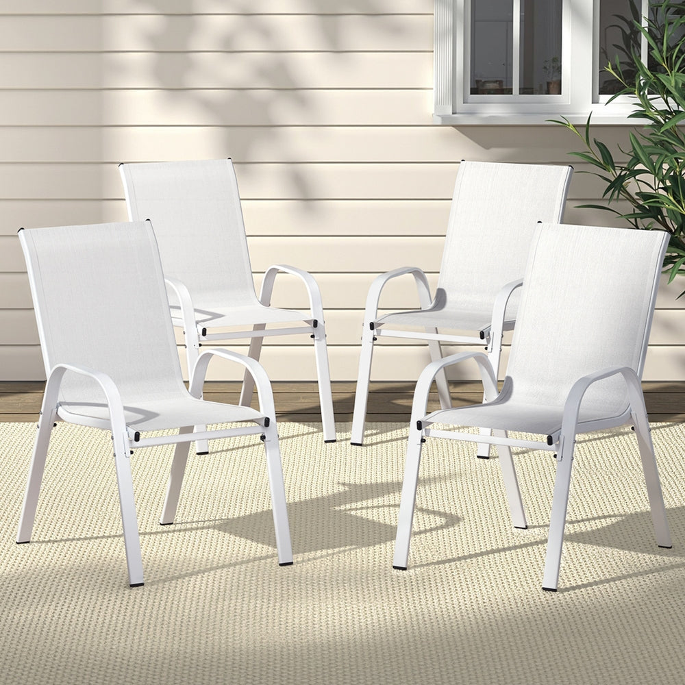 Four white outdoor chairs on a patio with a neutral background