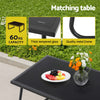 Black outdoor table with fruit plate and flowers on grass background, featuring text about capacity and materials.