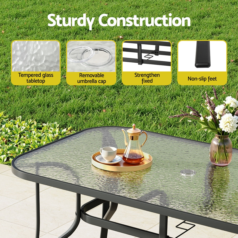 Outdoor glass table with features highlighted on a grassy background