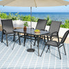 Outdoor patio set with table, chairs, and umbrella on a tiled patio with ocean view.