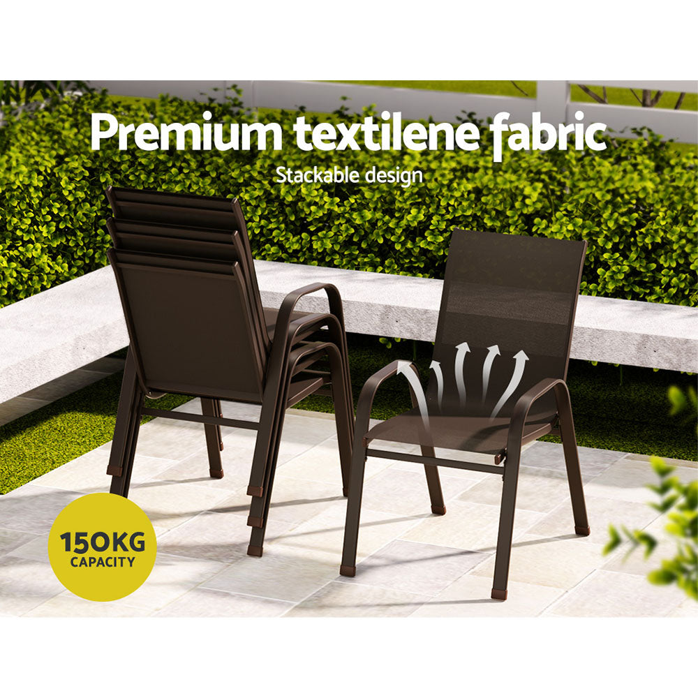 Four outdoor dining chairs in brown made of metal and plastic, a stackable design with anti-slip feet, 3 are stacked facing away and one is facing forwards in an outdoor garden setting.