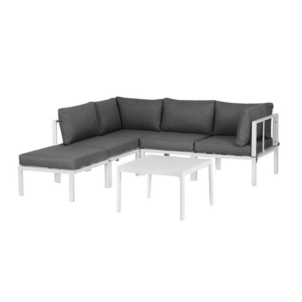 Sectional outdoor sofa with dark cushions and white frame on a white background