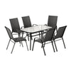 Outdoor dining set with a table and six chairs on a white background