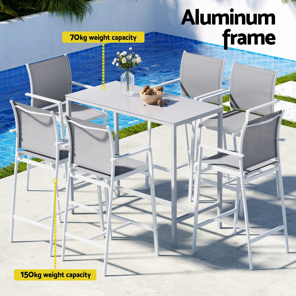 Outdoor dining set with table and chairs by a pool, featuring an aluminum frame.