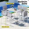 Outdoor dining set with table and chairs by a pool, featuring an aluminum frame.