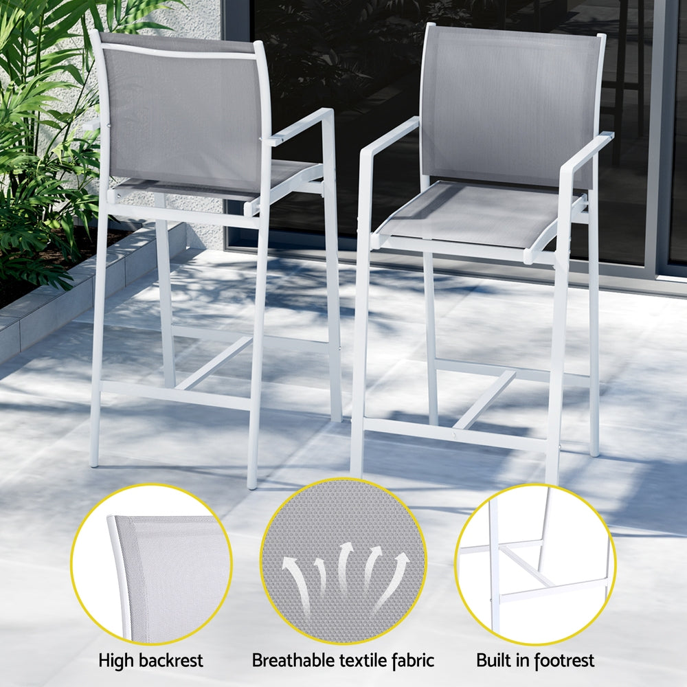 Two outdoor chairs with gray cushions on a patio, featuring high backrest, breathable textile fabric, and built-in footrest.