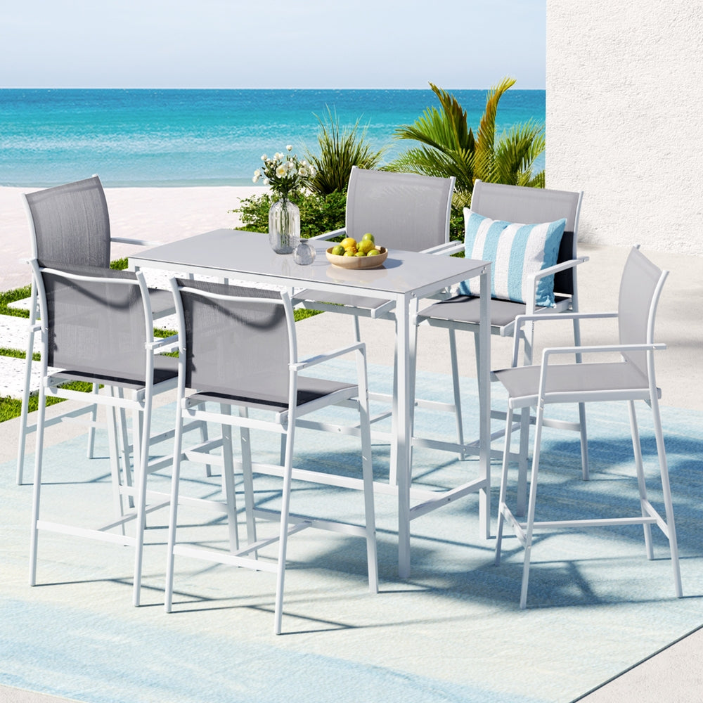 Outdoor dining set with table and chairs by the beach