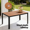 Wood plastic tabletop outdoor table with umbrella hole, placed on a patio.