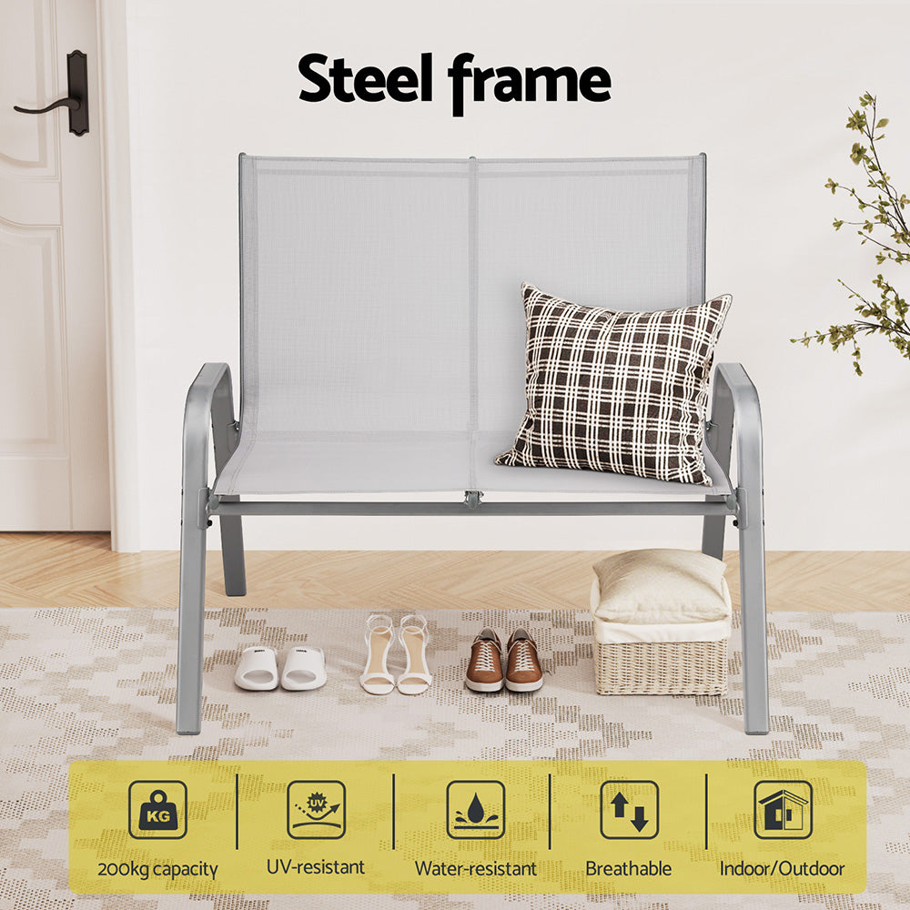 Gray outdoor bench with a cushion on a wooden floor, labeled 'Steel frame'.