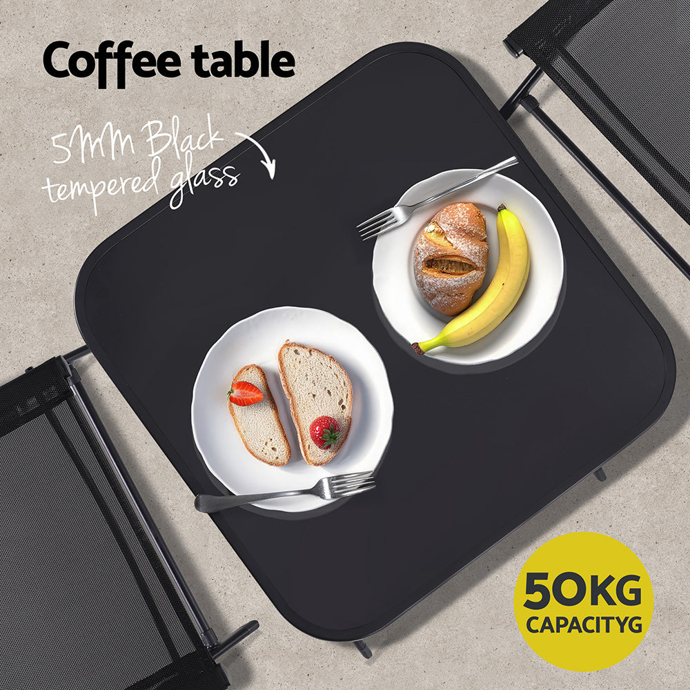 Black coffee table with two plates of food and a yellow capacity label.
