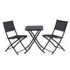 Black folding table with two chairs on a white background