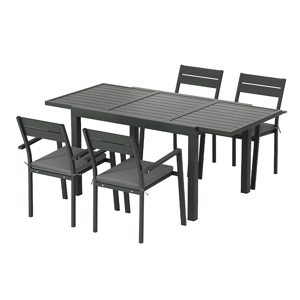 A five-piece outdoor dining set with a rectangular extending dining table in the extended size, with four grey aluminium chairs and cushions, on a white background.