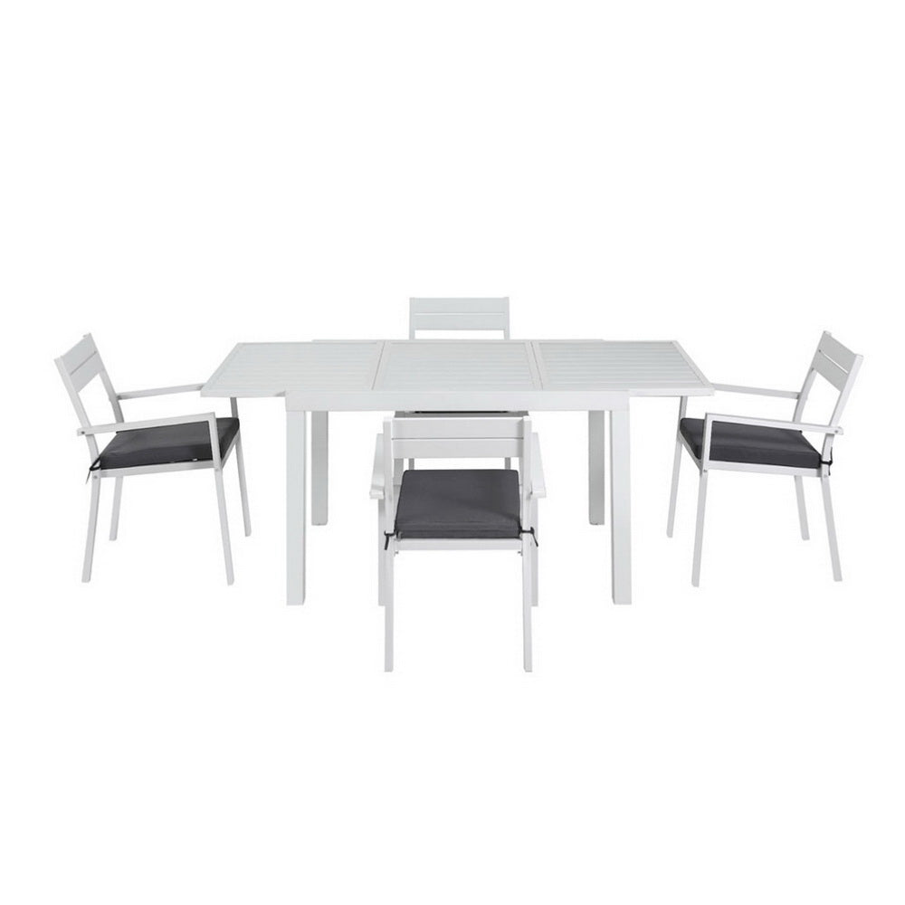 White dining table with four matching chairs on a white background