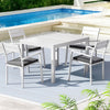 Outdoor dining set with table and chairs by a pool