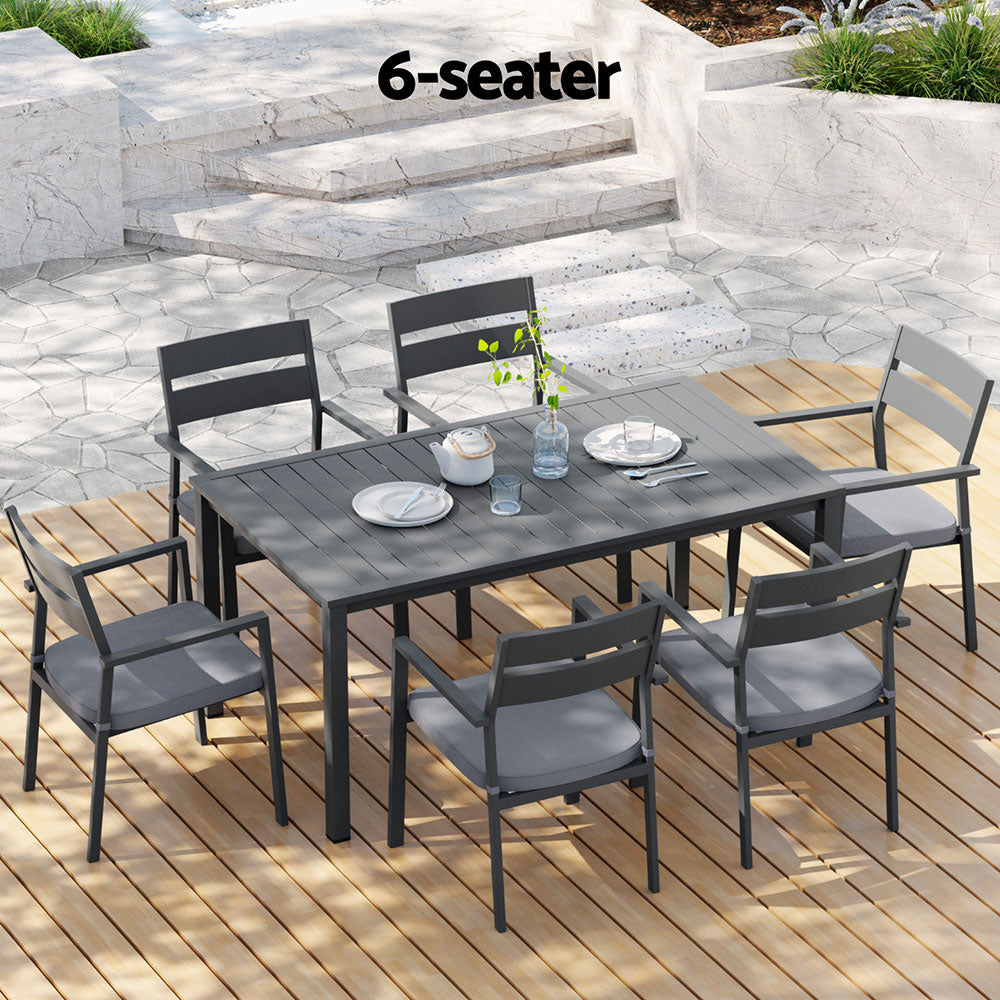 Outdoor dining set with a table and six chairs on a wooden deck, labeled '6-seater'.