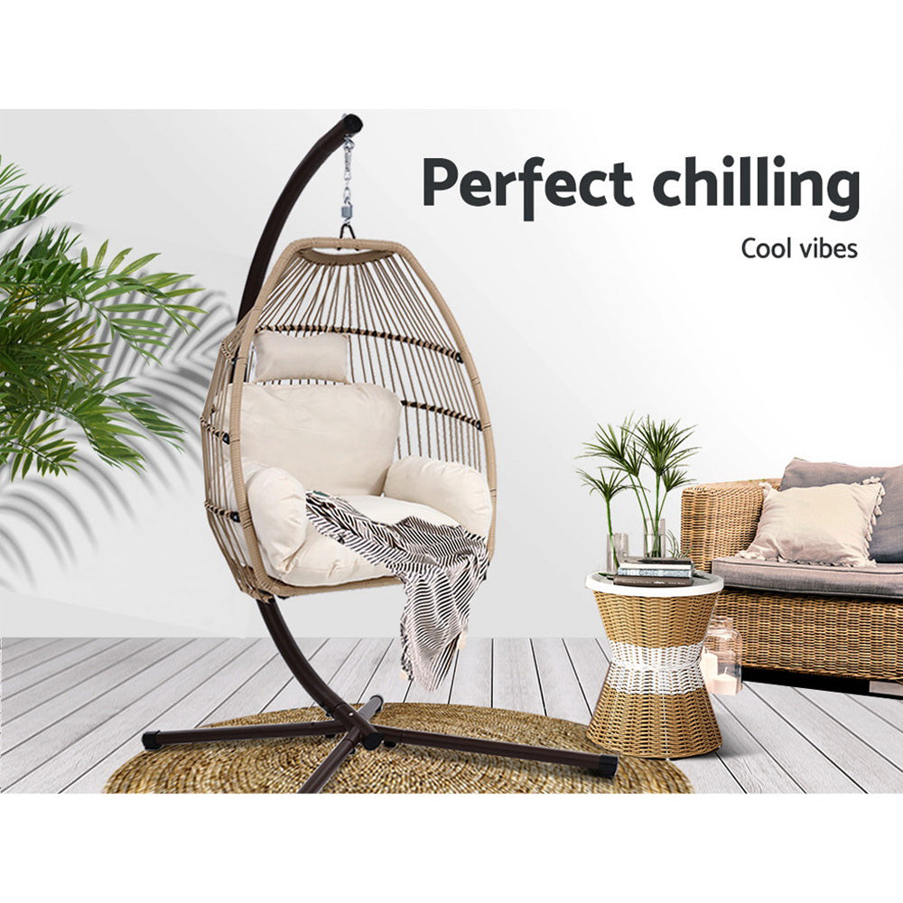 Hanging egg chair with text 'Perfect chilling Cool vibes' in a home setting.