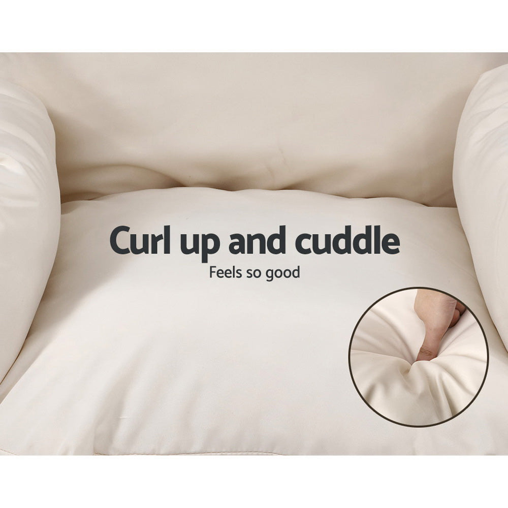 Beige cushion with text 'Curl up and cuddle Feels so good' and close-up of soft texture.