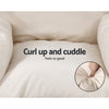 Beige cushion with text 'Curl up and cuddle Feels so good' and close-up of soft texture.