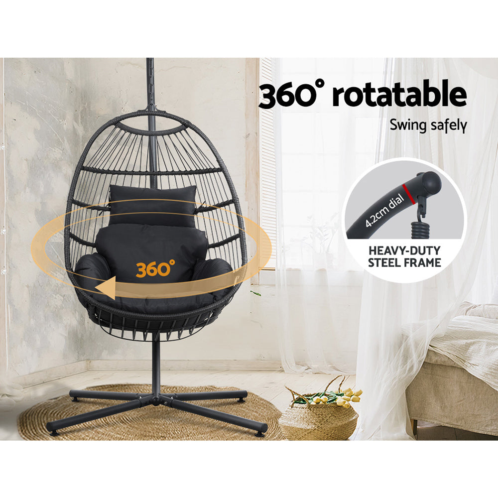 Black 360-degree rotatable hanging chair with a heavy-duty steel frame in a room setting.