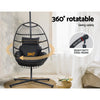 Black 360-degree rotatable hanging chair with a heavy-duty steel frame in a room setting.