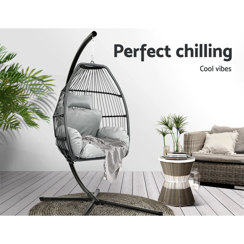 Hanging egg chair with cushions in a modern living room setting with text 'Perfect chilling Cool vibes'.