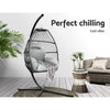 Hanging egg chair with cushions in a modern living room setting with text 'Perfect chilling Cool vibes'.