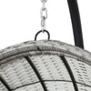 Top view where chain hangs from an outdoor egg swing chair with a grey wicker frame, and charcoal stand on a white background.