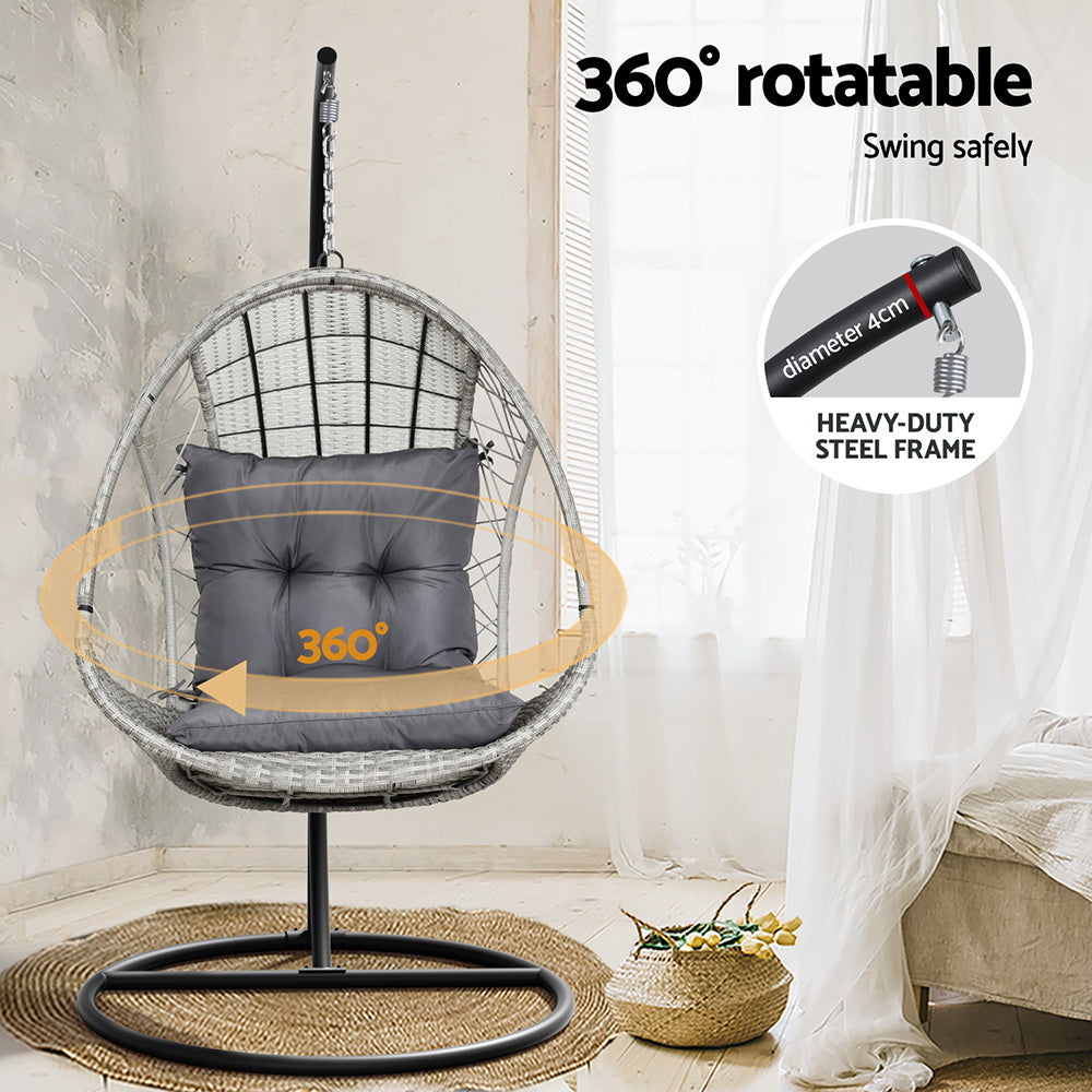 360-degree rotatable hanging chair with gray cushion in a room setting.