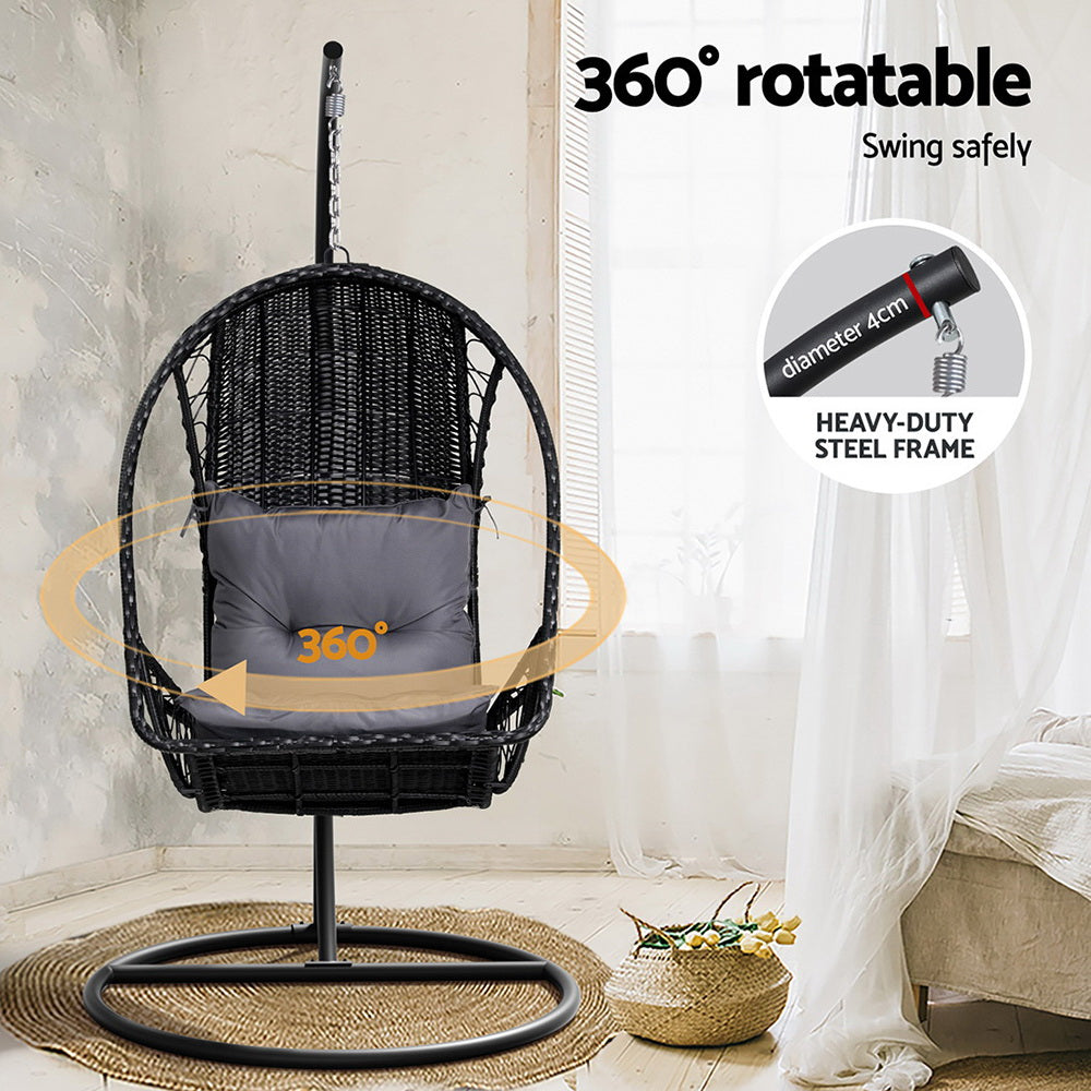 Black wicker swing chair with gray cushion in a room setting, featuring '360° rotatable' text.