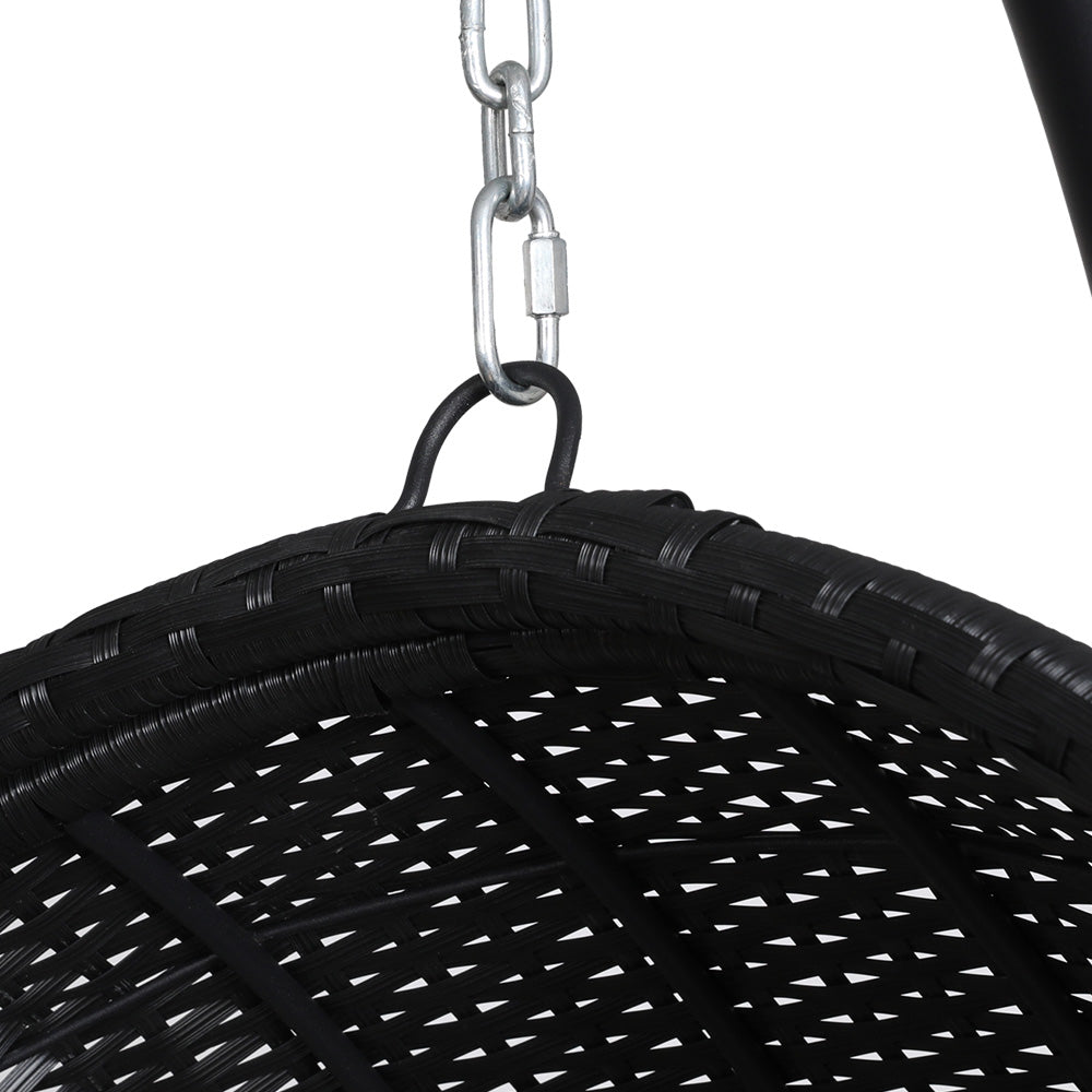 Top of a black wicker outdoor egg swing chair showing its chain and how it hangs, set on a white background.