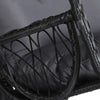 Close-up of a side view of an outdoor egg swing chair with a black wicker frame and grey cushions. 