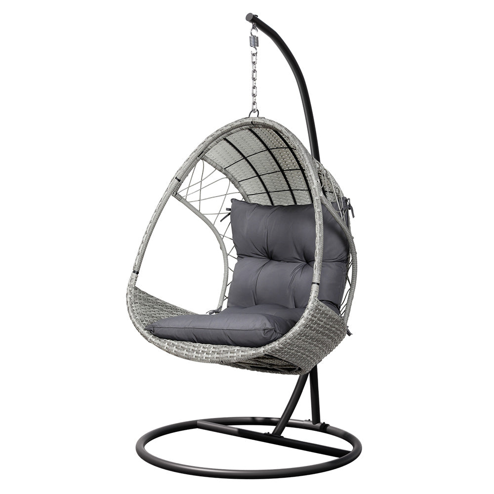 An outdoor egg swing chair with a grey wicker frame, charcoal stand and cushions on a white background.