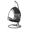 An outdoor egg swing chair with a black wicker frame and stand, featuring a gray cushion.