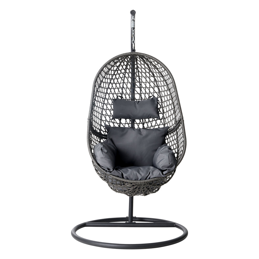 Black woven hanging chair with cushions on a white background
