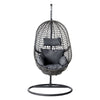 Black woven hanging chair with cushions on a white background