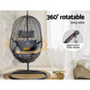 360-degree rotatable egg-shaped hanging chair with a heavy-duty steel frame in a room setting.